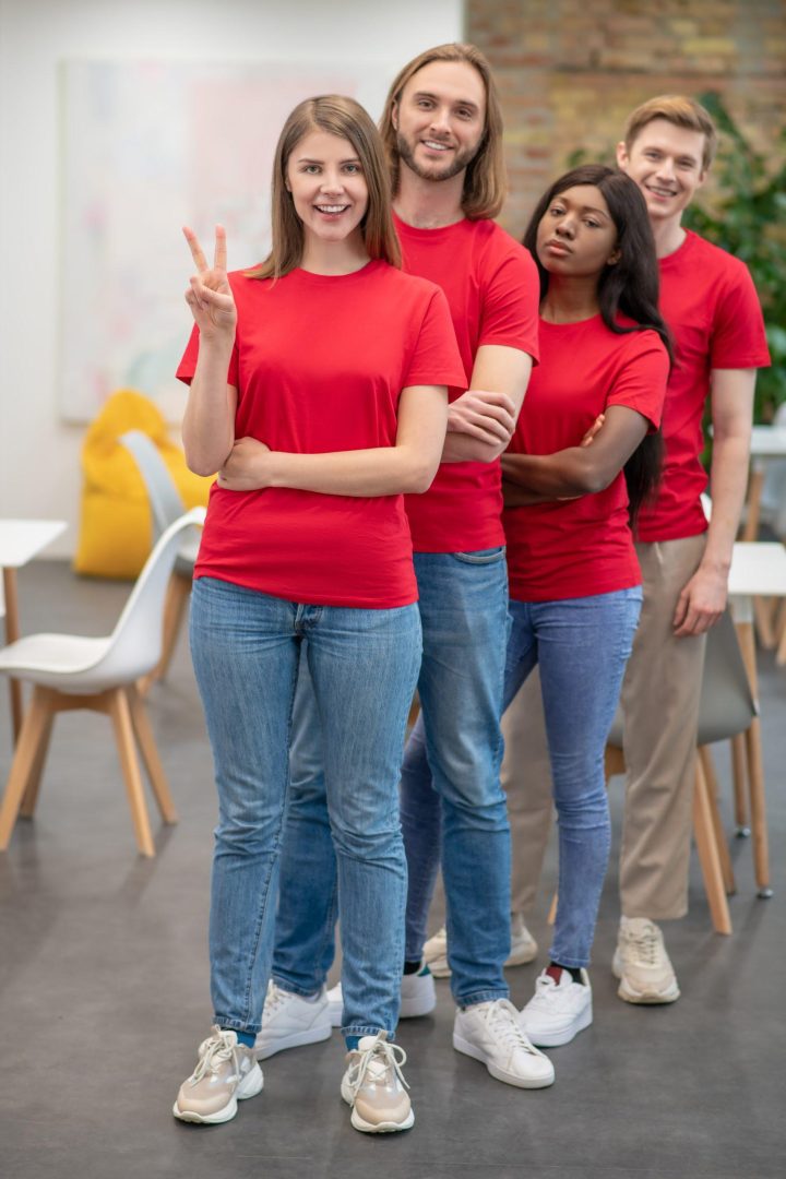 young people in red tshirts looking joyful and happy